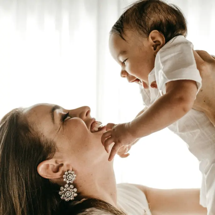 woman holding baby up